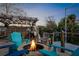 Fire pit area with teal chairs on a patio overlooking the water at 5421 Circle Dr, Weeki Wachee, FL 34607