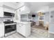 Modern kitchen featuring white cabinets, stainless steel appliances, and a breakfast bar at 5421 Circle Dr, Weeki Wachee, FL 34607