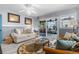 Cozy living room featuring a comfy sofa, wicker chairs, and a round coffee table at 5421 Circle Dr, Weeki Wachee, FL 34607