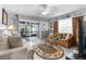 Bright living room with comfy sofas, a coffee table, and sliding glass doors leading to a patio at 5421 Circle Dr, Weeki Wachee, FL 34607