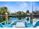 Relaxing waterfront view with blue Adirondack chairs and a table at 5421 Circle Dr, Weeki Wachee, FL 34607