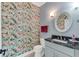 Stylish bathroom with floral wallpaper and granite countertop at 5608 Rockfield Loop, Valrico, FL 33596