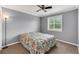 Bedroom with ceiling fan, wood floors, and window with blinds at 5608 Rockfield Loop, Valrico, FL 33596