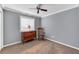 Cozy bedroom featuring a vintage dresser and rocking chair at 5608 Rockfield Loop, Valrico, FL 33596