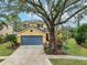 Two-story house with gray garage door and landscaped yard at 5608 Rockfield Loop, Valrico, FL 33596