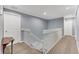 Upstairs hallway with neutral carpeting and white railings at 5608 Rockfield Loop, Valrico, FL 33596