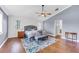 Main bedroom with wood floors, a ceiling fan, and access to the ensuite bathroom at 5608 Rockfield Loop, Valrico, FL 33596