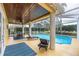 Screened-in pool and patio area with lounge chairs and dining table at 5608 Rockfield Loop, Valrico, FL 33596