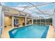 Inviting screened-in pool with spacious patio and covered seating area at 5608 Rockfield Loop, Valrico, FL 33596