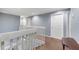 Upstairs hallway with neutral paint, carpet, and white railings at 5608 Rockfield Loop, Valrico, FL 33596