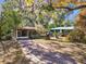 Cute bungalow with screened porch, mature trees, and a spacious yard at 5620 Montana Ave, New Port Richey, FL 34652