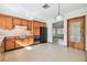 Kitchen with wood cabinets, black appliances, and view of dining area at 5620 Montana Ave, New Port Richey, FL 34652