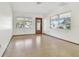 Bright living room with wood flooring and large windows at 5620 Montana Ave, New Port Richey, FL 34652