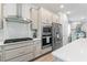 Modern kitchen with stainless steel appliances and white quartz countertops at 5636 Silver Sun Dr, Apollo Beach, FL 33572