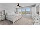 Main bedroom with king-size bed, dresser, and ceiling fan at 5636 Silver Sun Dr, Apollo Beach, FL 33572