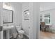 Stylish powder room with pedestal sink, toilet, and patterned floor at 5636 Silver Sun Dr, Apollo Beach, FL 33572