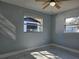 Bright bedroom with ceiling fan and view of the backyard at 6413 N 48Th St, Tampa, FL 33610