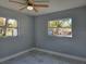 Bright bedroom with two windows and ceiling fan at 6413 N 48Th St, Tampa, FL 33610