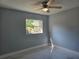 Cheerful bedroom with window and ceiling fan at 6413 N 48Th St, Tampa, FL 33610