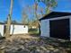 Newly painted garage with black roll-up door, providing extra storage space at 6413 N 48Th St, Tampa, FL 33610