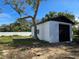 Detached garage with black roll-up door and white painted walls at 6413 N 48Th St, Tampa, FL 33610