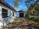 Detached garage with black door, offering extra storage at 6413 N 48Th St, Tampa, FL 33610