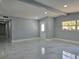 Open living room with gray walls, recessed lighting and marble floors at 6413 N 48Th St, Tampa, FL 33610