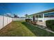 Fenced backyard featuring a well-maintained lawn, side yard area, and landscaping at 6909 13Th N Ave, St Petersburg, FL 33710