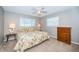 Comfortable bedroom with a floral patterned bedspread and a wooden dresser at 6909 13Th N Ave, St Petersburg, FL 33710