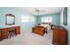 Bright bedroom with light blue walls, carpet flooring, and wooden furniture at 6909 13Th N Ave, St Petersburg, FL 33710