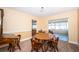 Cozy dining room with a round wood table and seating for four, adjacent to a sunroom with natural light at 6909 13Th N Ave, St Petersburg, FL 33710