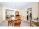 Traditional dining room with carpet flooring, a round table with wood chairs, and open access to the living area at 6909 13Th N Ave, St Petersburg, FL 33710