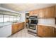 A well-lit kitchen with appliances, cabinetry, and countertops, offering space and functionality at 6909 13Th N Ave, St Petersburg, FL 33710