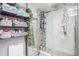 Modern bathroom with walk-in shower, gray tile, and storage shelves at 8907 N Boulevard, Tampa, FL 33604