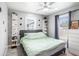 Bright bedroom with a green comforter, built in shelves, and ceiling fan at 8907 N Boulevard, Tampa, FL 33604