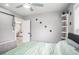 Light and airy bedroom with a green duvet, built in shelves and ceiling fan at 8907 N Boulevard, Tampa, FL 33604