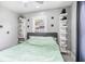 Spacious bedroom with a green comforter and floating shelves at 8907 N Boulevard, Tampa, FL 33604