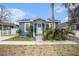 Charming blue house with white door, landscaping, and walkway at 8907 N Boulevard, Tampa, FL 33604