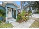 Front entryway features a white door, gray stone accents, and lush tropical plants at 8907 N Boulevard, Tampa, FL 33604