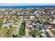 Stunning aerial view of a waterfront neighborhood, showcasing houses, private pools, and lush landscaping with beautiful ocean views at 924 Landmark S Cir, Tierra Verde, FL 33715