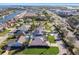 An aerial perspective captures a residential neighborhood featuring single-Gathering homes, pools, lush landscaping, and nearby highway at 924 Landmark S Cir, Tierra Verde, FL 33715