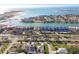 Wide aerial view captures homes near the coastline, with boat docks lining the waterway, sandy beach, and ocean views at 924 Landmark S Cir, Tierra Verde, FL 33715