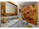 Updated bathroom with granite vanity and sunflower shower curtain at 9341 Blind Pass Rd, St Pete Beach, FL 33706