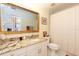 Bathroom with granite countertop, white cabinets, and a shower/tub combo at 9341 Blind Pass Rd, St Pete Beach, FL 33706