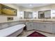 Bathroom featuring a corner vanity, soaking tub, and walk-in shower at 9341 Blind Pass Rd, St Pete Beach, FL 33706