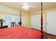 Main bedroom with a post bed, ceiling fan and bay window at 9341 Blind Pass Rd, St Pete Beach, FL 33706