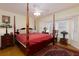 Main bedroom with a post bed, ceiling fan, and bay window at 9341 Blind Pass Rd, St Pete Beach, FL 33706