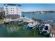 Aerial view of boat docks with several boats and a waterfront building at 9341 Blind Pass Rd, St Pete Beach, FL 33706