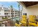 Shared balcony with yellow chairs and a view of the pool at 9341 Blind Pass Rd, St Pete Beach, FL 33706