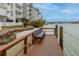 Wooden waterfront dock with bench and views of the bay at 9341 Blind Pass Rd, St Pete Beach, FL 33706